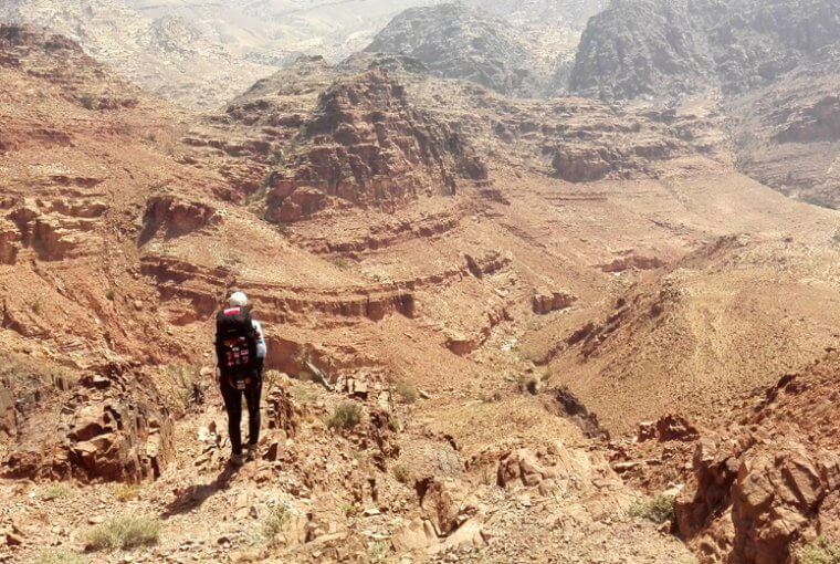 Trekken durch Jordanien - Jennifer blickt auf die karge aber beeindruckende Landschaft nahe Feynan in Jordanien.